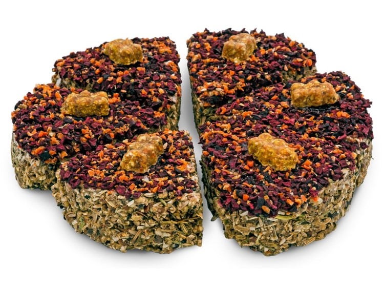 Naturlig snack til gnavere, formet som en kage, bestående af tørrede frugter og grøntsager, ideel til hamstere, marsvin og andre små kæledyr. Perfekt til belønning eller som supplement til deres kost.